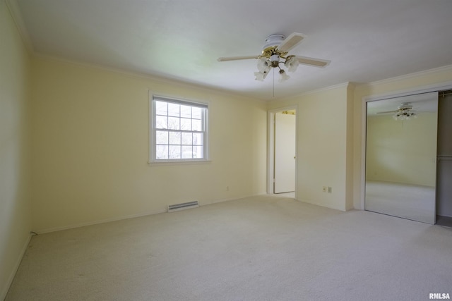 unfurnished bedroom featuring crown molding, carpet flooring, visible vents, baseboards, and a closet