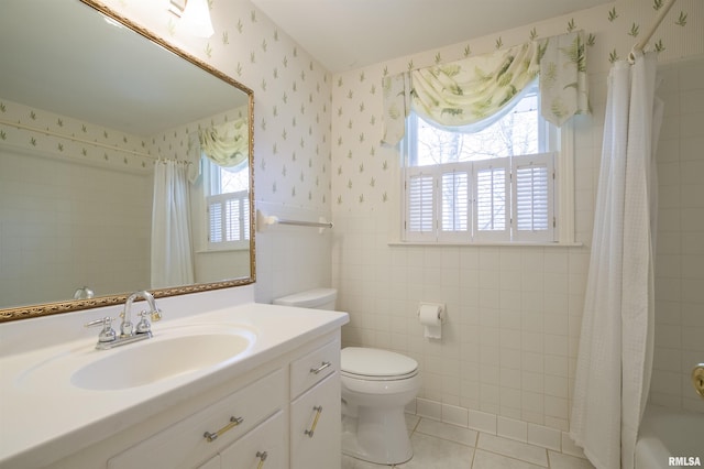 full bathroom featuring wallpapered walls, toilet, shower / bath combination with curtain, tile patterned floors, and vanity