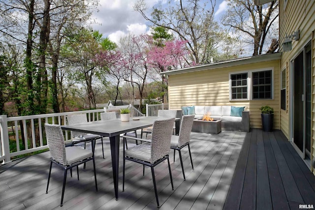 deck featuring a fire pit and outdoor dining area