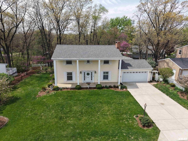 view of front of house featuring driveway, a chimney, fence, a front lawn, and a garage