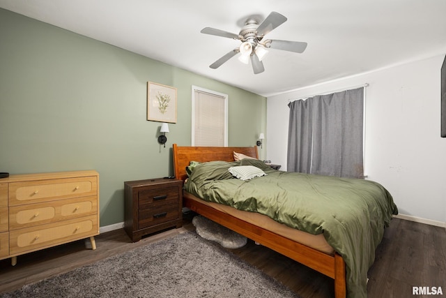 bedroom featuring wood finished floors, a ceiling fan, and baseboards