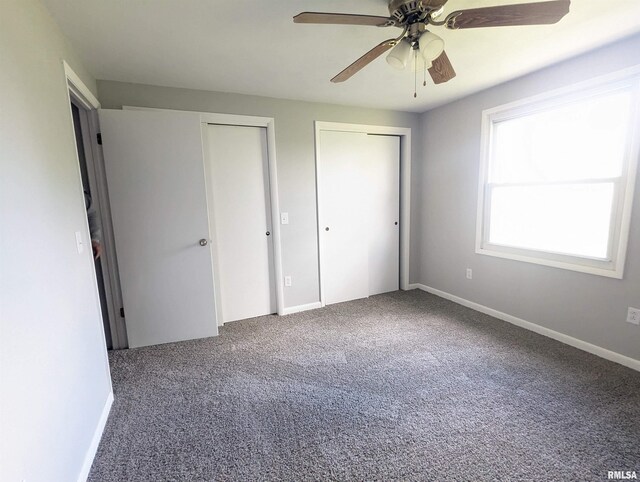 3809 N Fisk Rd, Astoria, IL 61501 - unfurnished bedroom featuring baseboards, a ceiling fan, carpet floors, and multiple closets