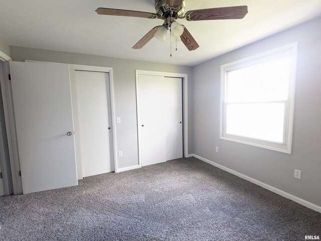 3809 N Fisk Rd, Astoria, IL 61501 - unfurnished bedroom featuring baseboards, ceiling fan, carpet, and multiple closets