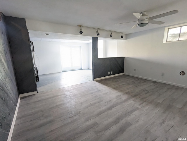 3809 N Fisk Rd, Astoria, IL 61501 - unfurnished room featuring visible vents, baseboards, rail lighting, wood finished floors, and a ceiling fan
