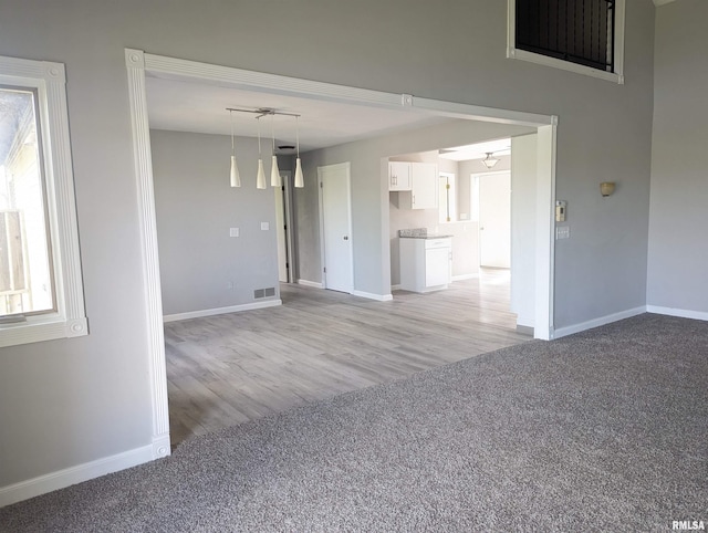 3809 N Fisk Rd, Astoria, IL 61501 - spare room with a ceiling fan, visible vents, light wood-style flooring, and baseboards