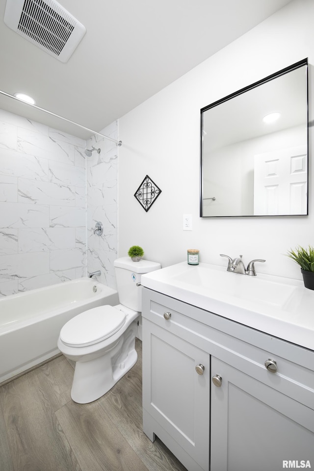 504 N 4th St, Dunlap, IL 61525 - bathroom with visible vents, wood finished floors, vanity, toilet, and  shower combination