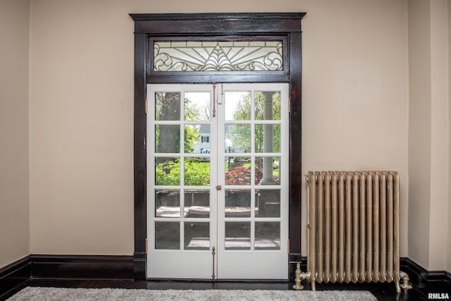 interior space featuring baseboards and radiator