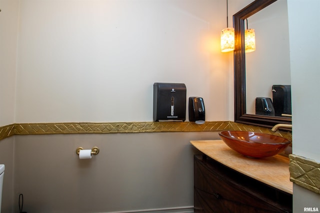 half bathroom featuring toilet and vanity