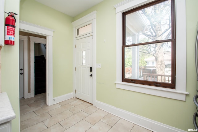 foyer featuring light tile patterned floors and baseboards