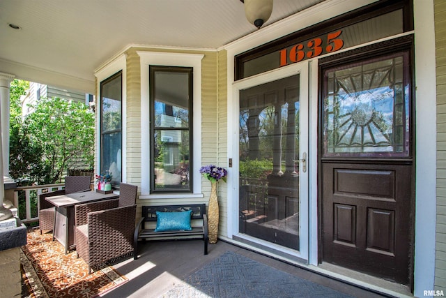 view of exterior entry with covered porch