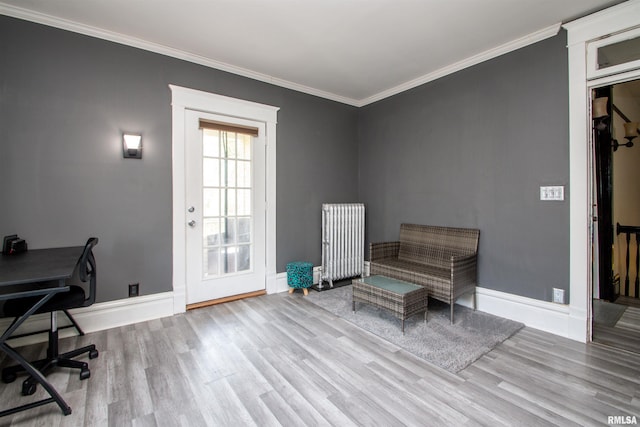interior space with baseboards, radiator heating unit, wood finished floors, and crown molding
