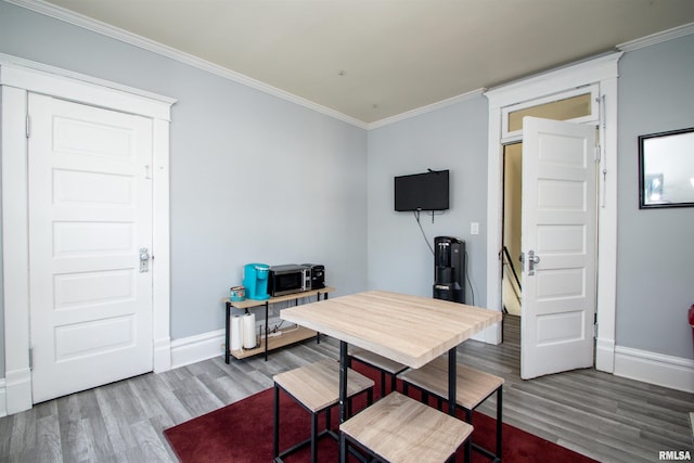 office with crown molding, wood finished floors, and baseboards