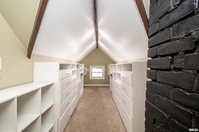 spacious closet featuring lofted ceiling and light carpet
