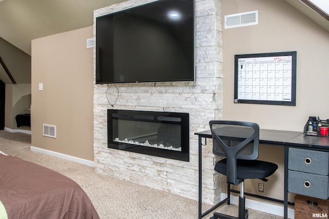 carpeted bedroom with baseboards, visible vents, a fireplace, and vaulted ceiling