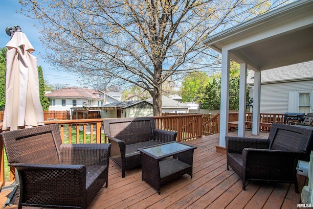 wooden deck with a residential view, an outdoor living space, and a fenced backyard