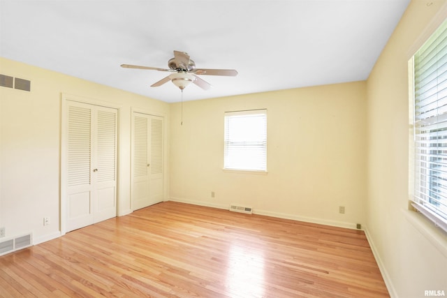 unfurnished bedroom featuring visible vents and multiple windows