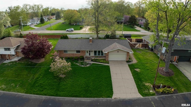 view of front of home with driveway, a residential view, brick siding, and a garage