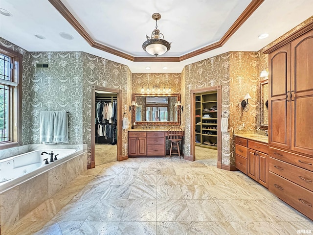bathroom with two vanities, a sink, a whirlpool tub, a spacious closet, and ornamental molding