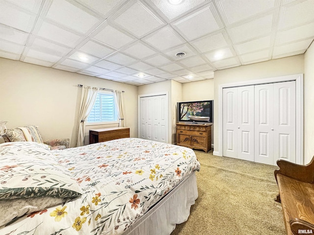 bedroom featuring recessed lighting, carpet flooring, two closets, and visible vents