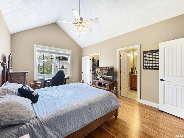 bedroom featuring a walk in closet, ensuite bath, high vaulted ceiling, a ceiling fan, and light wood-type flooring