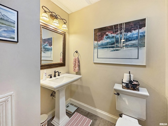 bathroom featuring baseboards and toilet