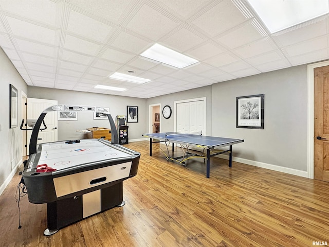 game room featuring baseboards and light wood-style flooring