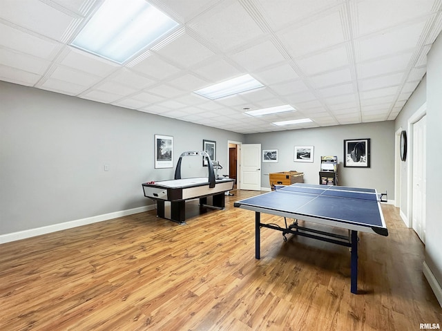 rec room featuring baseboards and light wood-style flooring