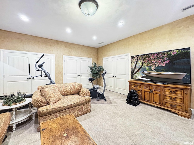 carpeted living room featuring recessed lighting and visible vents