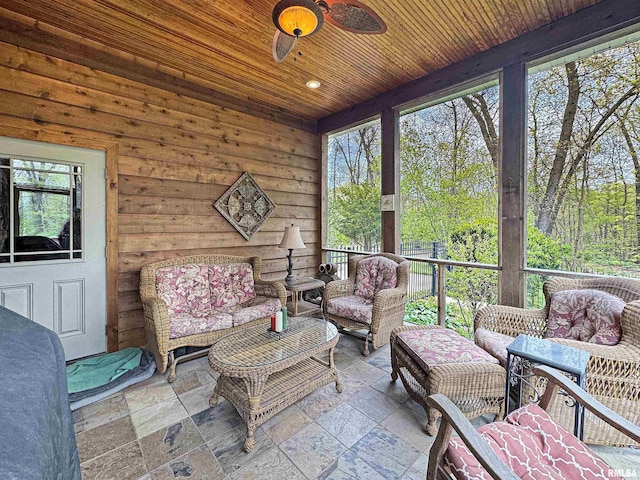 sunroom featuring ceiling fan and outdoor lounge area