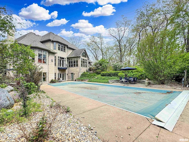 view of swimming pool with a covered pool and a patio area