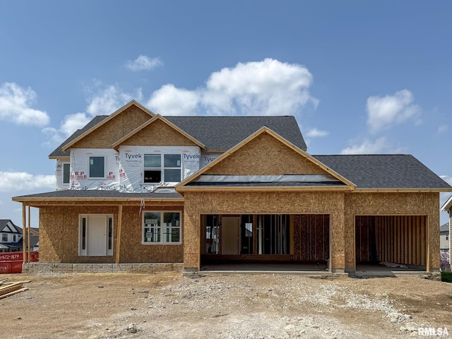 property under construction with a shingled roof and an attached garage