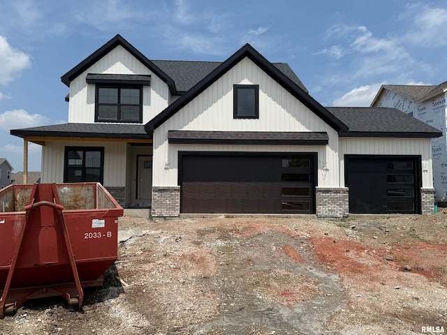 2609 W Arden Way, Dunlap, IL 61525 - view of front of house featuring brick siding, a shingled roof, a garage, and covered porch