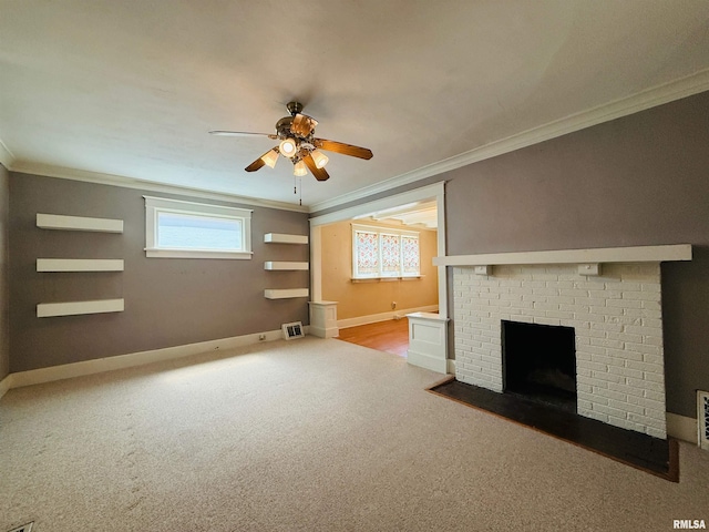 unfurnished living room with ornamental molding, a ceiling fan, a brick fireplace, and carpet floors