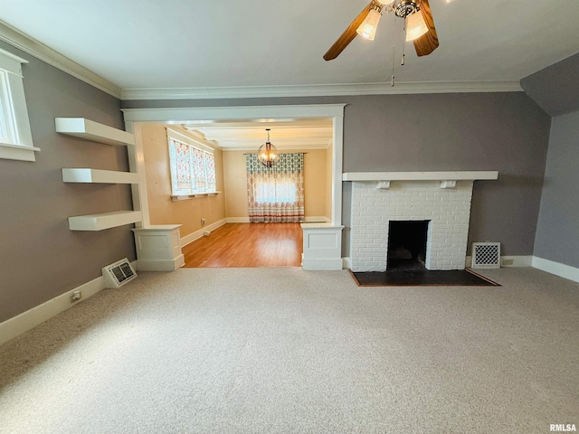 unfurnished living room with carpet, ornamental molding, baseboards, visible vents, and a ceiling fan