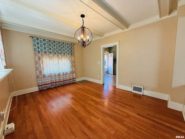 empty room featuring wood finished floors, visible vents, a healthy amount of sunlight, and a notable chandelier