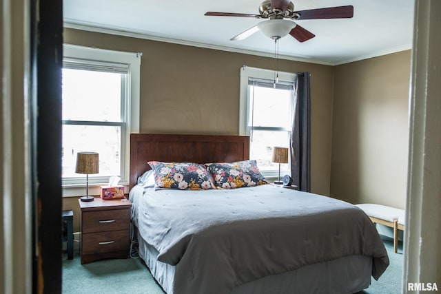 bedroom featuring crown molding, a ceiling fan, and carpet flooring