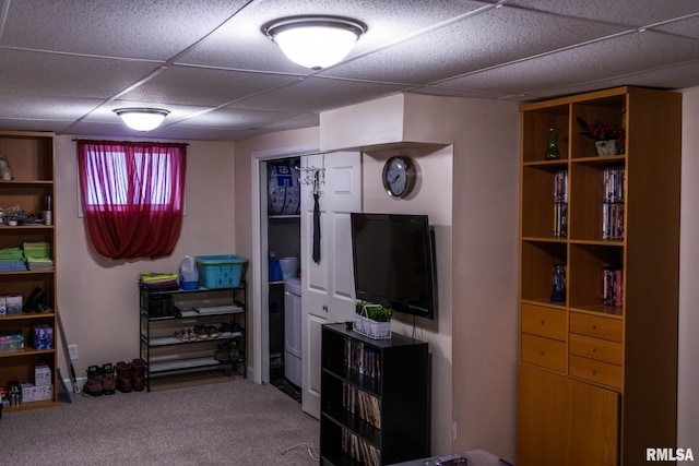 interior space with carpet flooring and a drop ceiling
