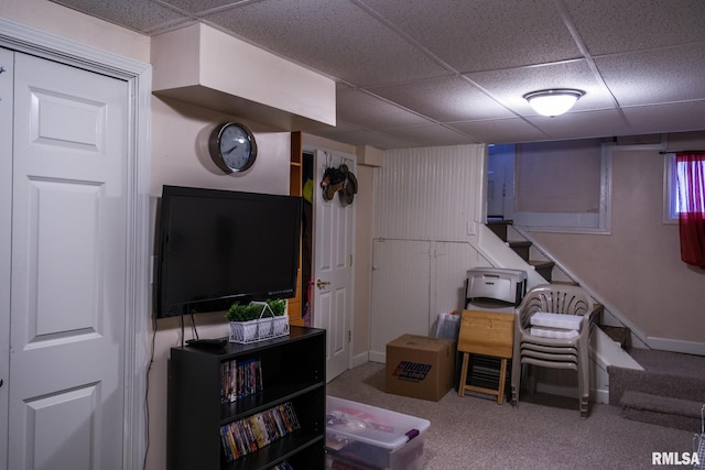 interior space with stairs, a drop ceiling, and carpet floors