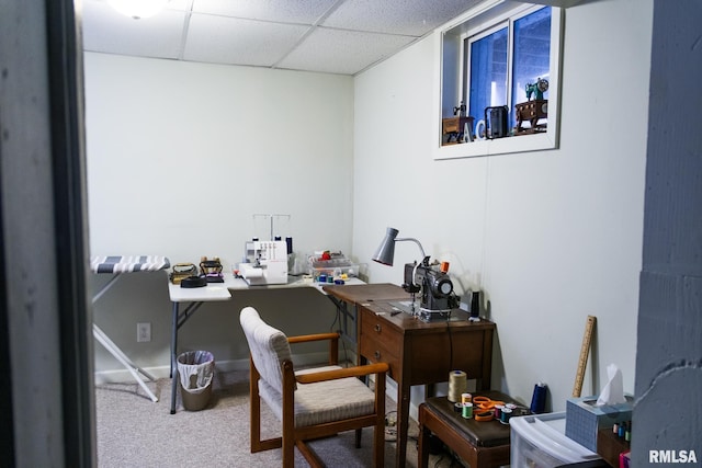 carpeted home office with a drop ceiling