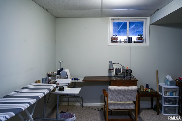 carpeted office space with a drop ceiling