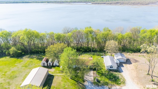 birds eye view of property featuring a wooded view and a water view