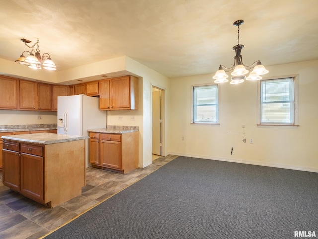 kitchen with white fridge with ice dispenser, a notable chandelier, a wealth of natural light, and light countertops