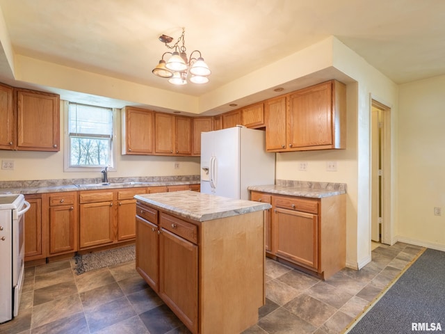 kitchen with white appliances, a chandelier, light countertops, a sink, and a center island