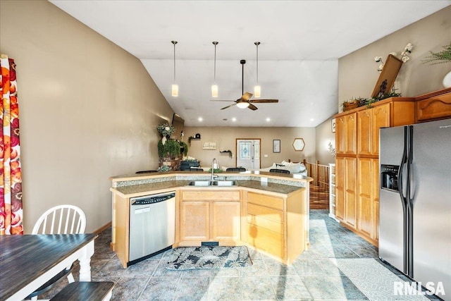 kitchen featuring decorative light fixtures, appliances with stainless steel finishes, vaulted ceiling, a sink, and a ceiling fan