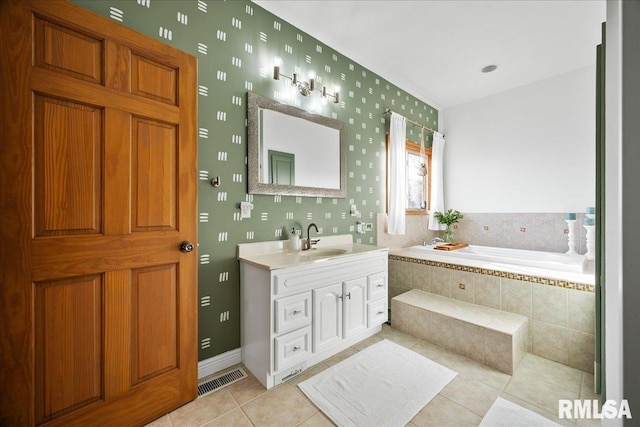 full bathroom with a bath, tile patterned flooring, visible vents, and vanity