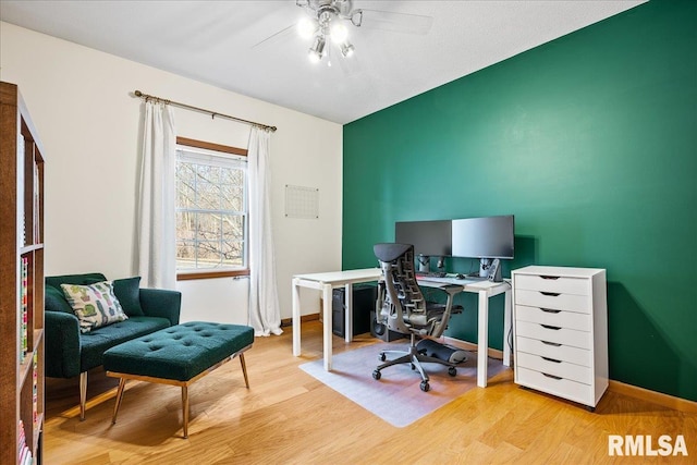 office area with wood finished floors, a ceiling fan, and baseboards