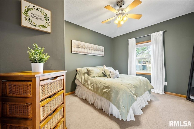 bedroom with baseboards, a ceiling fan, and light colored carpet
