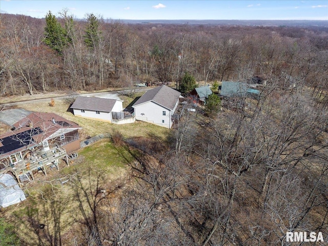 drone / aerial view with a wooded view