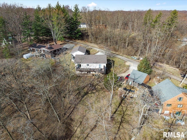 birds eye view of property featuring a wooded view