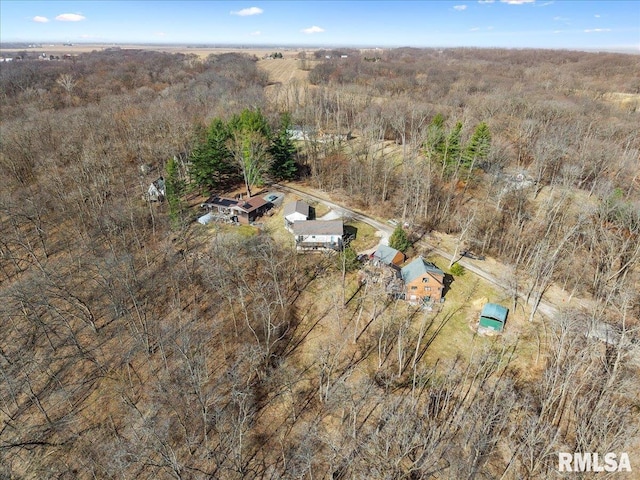 birds eye view of property featuring a wooded view